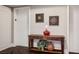 Hallway with dark herringbone floors, wooden console table, and decorative art at 2777 Paradise Rd # 1701, Las Vegas, NV 89109