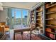 Elegant home office with built-in bookshelves, a ladder, hardwood floors, and a city view at 2777 Paradise Rd # 1701, Las Vegas, NV 89109