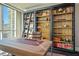 Well-appointed home office with custom bookshelf and ladder, desk, and ample natural light for a productive workspace at 2777 Paradise Rd # 1701, Las Vegas, NV 89109