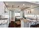 Luxury kitchen with custom cabinets, granite counters, stainless appliances, and an island at 2777 Paradise Rd # 1701, Las Vegas, NV 89109