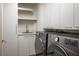 Contemporary laundry room featuring sleek cabinetry, modern washer and dryer, and a practical sink area at 2777 Paradise Rd # 1701, Las Vegas, NV 89109