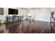 Spacious living room featuring gleaming hardwood floors and a stylish console under a large screen TV at 2777 Paradise Rd # 1701, Las Vegas, NV 89109
