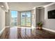 Bright living room featuring hardwood floors, large windows with natural light, and balcony access in a neutral color palette at 2777 Paradise Rd # 1701, Las Vegas, NV 89109