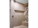 Shower featuring neutral tile, showerhead, a built-in shelf and seat with an accent tile for added visual interest at 2777 Paradise Rd # 1701, Las Vegas, NV 89109