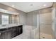 Bathroom featuring double sink vanity, bathtub and glass enclosed shower at 2853 Cabrillo Terrace St, Henderson, NV 89044