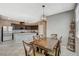 Open-concept dining area next to a spacious kitchen with stainless steel appliances and dark wood cabinets at 2853 Cabrillo Terrace St, Henderson, NV 89044