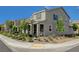 View of gray home showcasing manicured landscaping, sidewalks, and neighborhood charm at 2853 Cabrillo Terrace St, Henderson, NV 89044