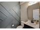 Stylish half bathroom featuring a modern vanity, unique wall design, and updated fixtures at 2853 Cabrillo Terrace St, Henderson, NV 89044