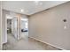 Hallway with neutral gray walls, carpet flooring, and open doorways to other rooms at 2853 Cabrillo Terrace St, Henderson, NV 89044