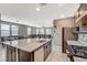 Open-concept kitchen with granite counters, stainless steel appliances, and a view into the dining and living areas at 2853 Cabrillo Terrace St, Henderson, NV 89044