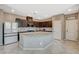 Modern kitchen features granite countertops, stainless steel appliances, dark wood cabinetry, and tiled floors at 2853 Cabrillo Terrace St, Henderson, NV 89044