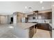 Spacious kitchen with a large island, granite countertops, stainless steel appliances, and dark cabinets at 2853 Cabrillo Terrace St, Henderson, NV 89044