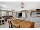 Open-concept living space with a dining table, kitchen, and comfortable leather sectional couch at 2853 Cabrillo Terrace St, Henderson, NV 89044