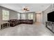 Bright and airy living room with tile flooring and a large leather sectional at 2853 Cabrillo Terrace St, Henderson, NV 89044