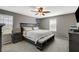 Well-lit main bedroom with soft carpet, ceiling fan, and dark wood furniture at 2853 Cabrillo Terrace St, Henderson, NV 89044