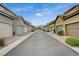 Charming neighborhood street with well-maintained townhomes and beautiful mountain views in the distance at 2853 Cabrillo Terrace St, Henderson, NV 89044