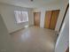 Bedroom showcasing tile floors, neutral paint, two closets, and natural light at 2859 Wheelwright Dr, Las Vegas, NV 89121