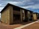 Exterior view of a two-story tan building featuring dark trim and landscaping at 2859 Wheelwright Dr, Las Vegas, NV 89121