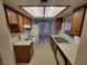 Kitchen with wooden cabinets, tile floors, and white appliances at 2859 Wheelwright Dr, Las Vegas, NV 89121