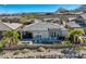 A beautiful home with a pool, mountain views, and desert landscaping at 2910 Raywood Ash Dr, Las Vegas, NV 89138