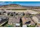 A beautiful aerial view shows the surrounding neighborhood and mountains at 2910 Raywood Ash Dr, Las Vegas, NV 89138