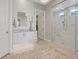Updated bathroom featuring a vanity with dual sinks, tiled wall, chandelier, and glass shower with a seat at 2910 Raywood Ash Dr, Las Vegas, NV 89138