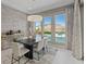 Bright dining room featuring a modern chandelier and scenic views of the pool and mountains at 2910 Raywood Ash Dr, Las Vegas, NV 89138