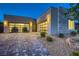 Contemporary home featuring a stylish three-car garage, stone accents, and desert landscaping at 2910 Raywood Ash Dr, Las Vegas, NV 89138