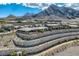 A wide view showcases beautiful desert landscaping, tiered walls, and an incredible mountain backdrop at 2910 Raywood Ash Dr, Las Vegas, NV 89138