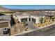 A spacious home with a modern garage, desert landscaping, and a wide driveway at 2910 Raywood Ash Dr, Las Vegas, NV 89138