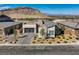 Stunning single-story home featuring a modern garage door and desert landscaping at 2910 Raywood Ash Dr, Las Vegas, NV 89138