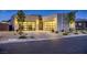 Striking modern home showcases a three-car garage, elegant stone details, and desert-friendly landscaping at 2910 Raywood Ash Dr, Las Vegas, NV 89138
