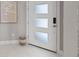 Modern entryway featuring frosted glass front door, marble floors and stylish decor at 2910 Raywood Ash Dr, Las Vegas, NV 89138