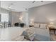 Spacious bedroom with tile floors, large windows, ceiling fan, and stylish furnishings at 2910 Raywood Ash Dr, Las Vegas, NV 89138