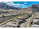 Scenic aerial view captures a desert community nestled against a mountain range with beautiful landscaping at 2910 Raywood Ash Dr, Las Vegas, NV 89138