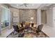 Inviting home office featuring a brick accent wall, a sleek ceiling fan, and a comfortable seating area at 2910 Raywood Ash Dr, Las Vegas, NV 89138
