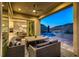 Covered outdoor space with a patio, comfortable seating, mountain views and a pool at 2910 Raywood Ash Dr, Las Vegas, NV 89138
