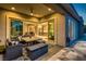 Covered outdoor space with a patio, comfortable seating, and views into the home at 2910 Raywood Ash Dr, Las Vegas, NV 89138