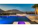 A luxurious pool with a spa and mountain views provides a relaxing backyard oasis at 2910 Raywood Ash Dr, Las Vegas, NV 89138