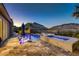 A luxurious pool with a mountain view and a lounge area provide a relaxing backyard oasis at 2910 Raywood Ash Dr, Las Vegas, NV 89138