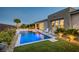 Backyard with a modern pool, lush landscaping, and outdoor seating at 2910 Raywood Ash Dr, Las Vegas, NV 89138