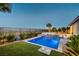 Backyard featuring a modern pool, lush landscaping, and views of the surrounding area at 2910 Raywood Ash Dr, Las Vegas, NV 89138