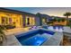 A luxurious pool and spa with lounge chairs and mountain views provide a relaxing backyard oasis at 2910 Raywood Ash Dr, Las Vegas, NV 89138
