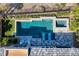 Aerial view of a modern pool and spa with lounge chairs, surrounded by lush landscaping and stylish patio at 2910 Raywood Ash Dr, Las Vegas, NV 89138
