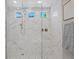 Upgraded shower with glass door, mosaic tile floor, rainfall shower head, and modern tile surround at 2910 Raywood Ash Dr, Las Vegas, NV 89138