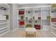 Spacious walk-in closet with a comfortable bench, custom shelving, and plenty of storage space at 2910 Raywood Ash Dr, Las Vegas, NV 89138