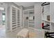 Bright walk-in closet featuring custom storage solutions, wood shelving, and a plush bench at 2910 Raywood Ash Dr, Las Vegas, NV 89138