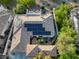 Aerial view of a home with a tile roof, solar panels, a rooftop deck, and an outdoor seating area at 2964 Via Della Amore, Henderson, NV 89052