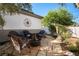 Cozy backyard featuring stone flooring, a fire pit, comfortable seating, and elegant decorative touches at 2964 Via Della Amore, Henderson, NV 89052