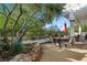Covered backyard patio area with wrought iron fence and mature trees at 2964 Via Della Amore, Henderson, NV 89052